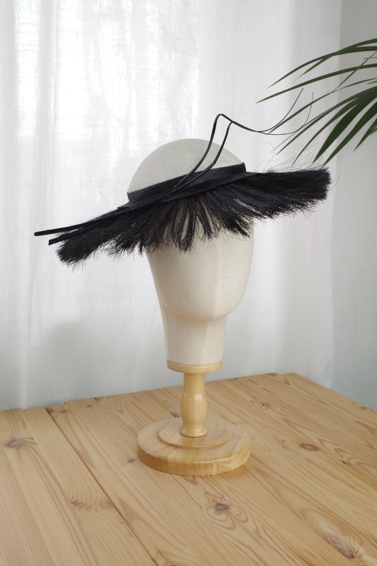 Side view of ivory sinamay occasion hat with crin fringe and feather quills by MICHAETT