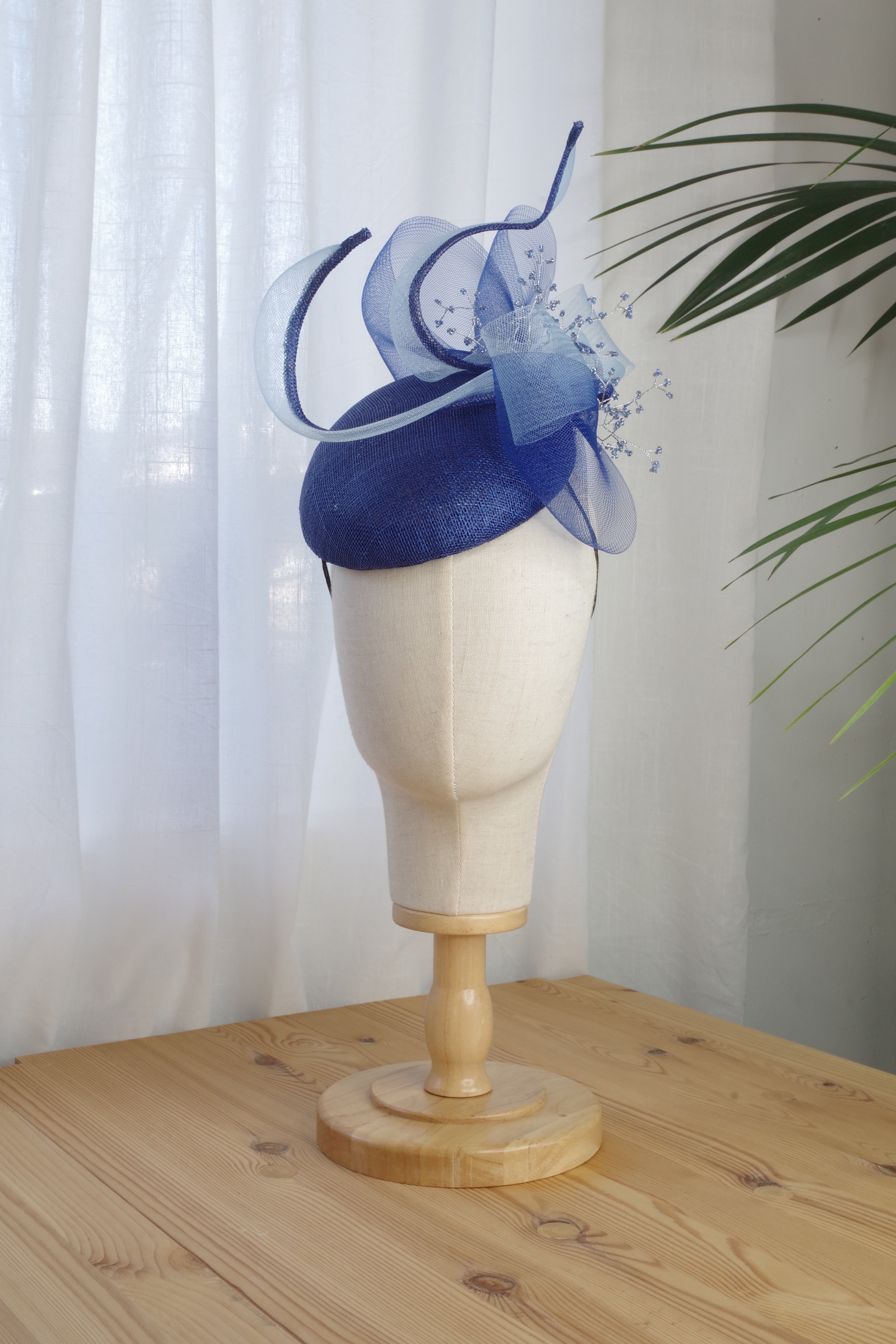 Sapphire Whirl navy sinamay cocktail hat with sculptural loops, bow and beaded detailing by MICHAETT