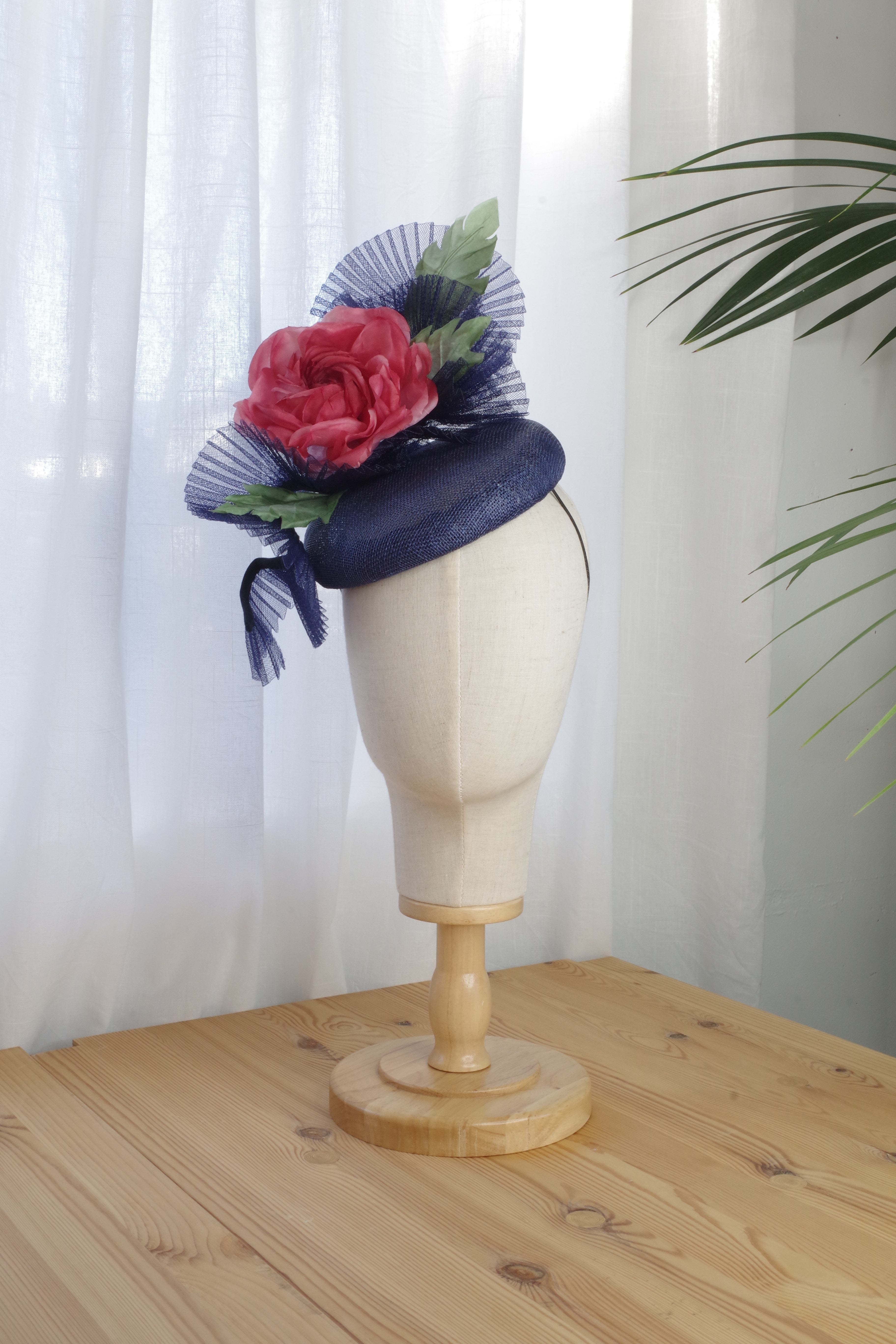 Handcrafted navy sinamay cocktail hat with a coral silk flower for the Melbourne Cup and race days by MICHAETT