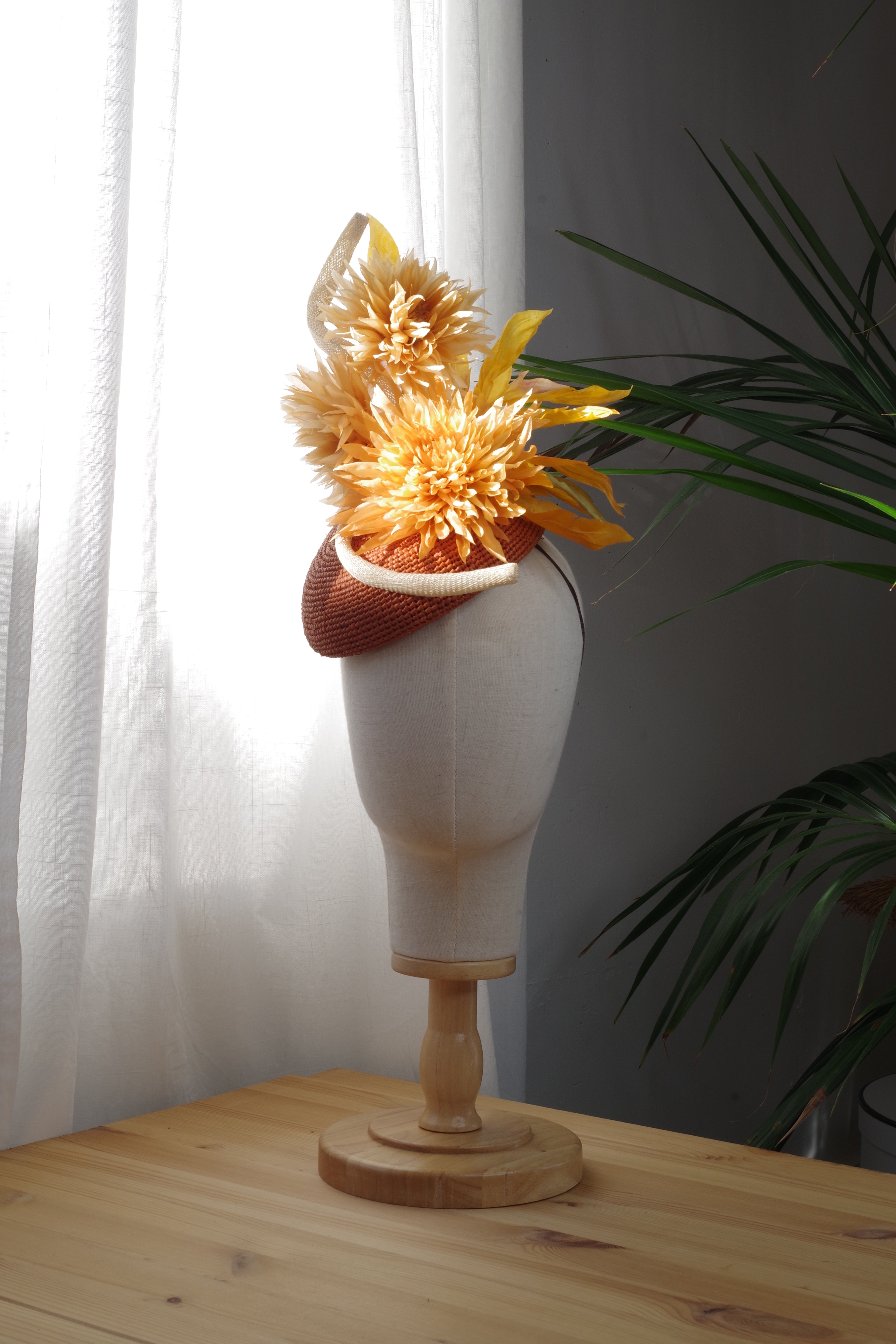 Handcrafted natural raffia cocktail hat by MICHAETT featuring sculptural golden silk dahlias, hand-shaped foliage and a couture silhouette, designed for the Melbourne Cup, race days, weddings and special occasions.