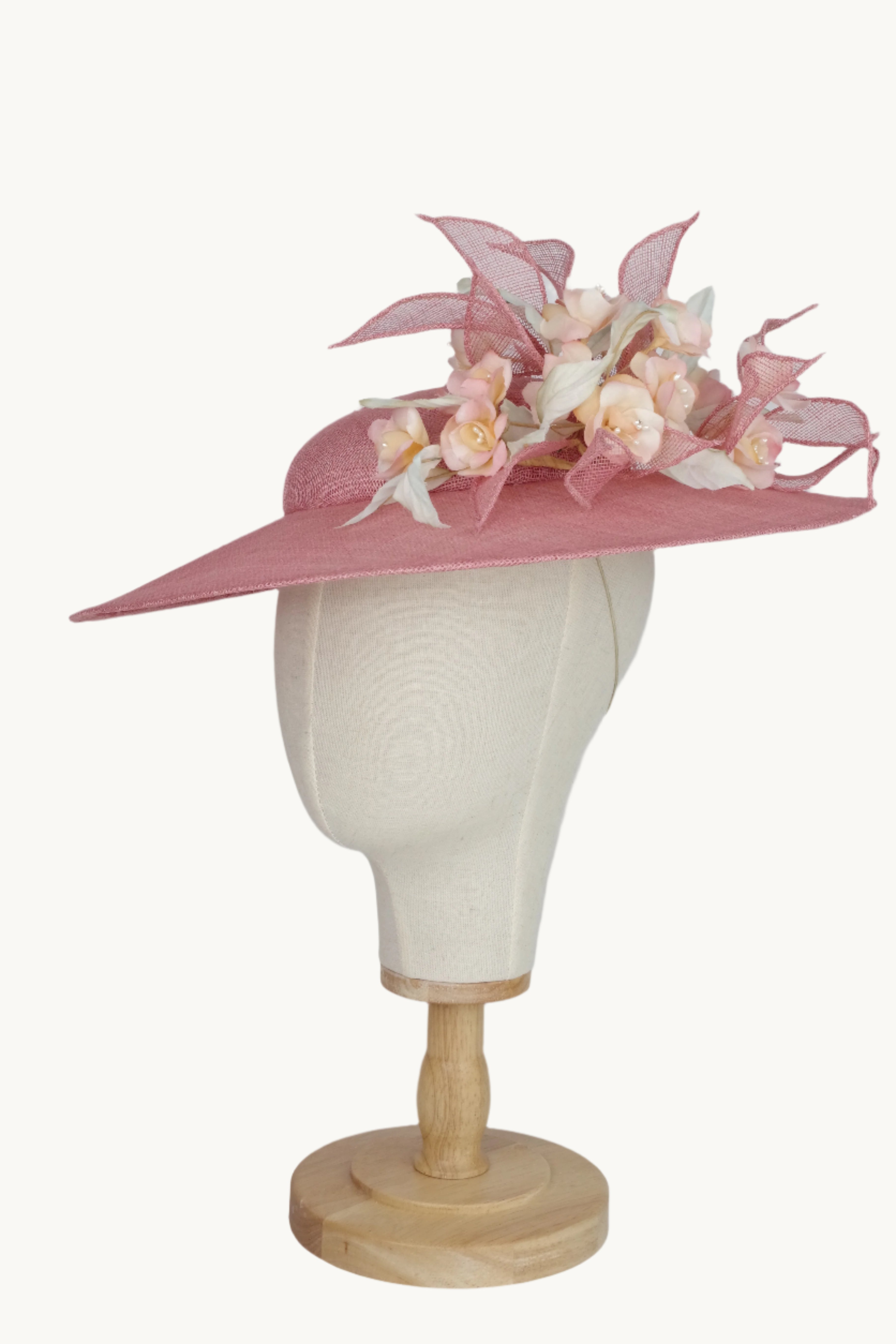 Pink decorative hat with floral details 