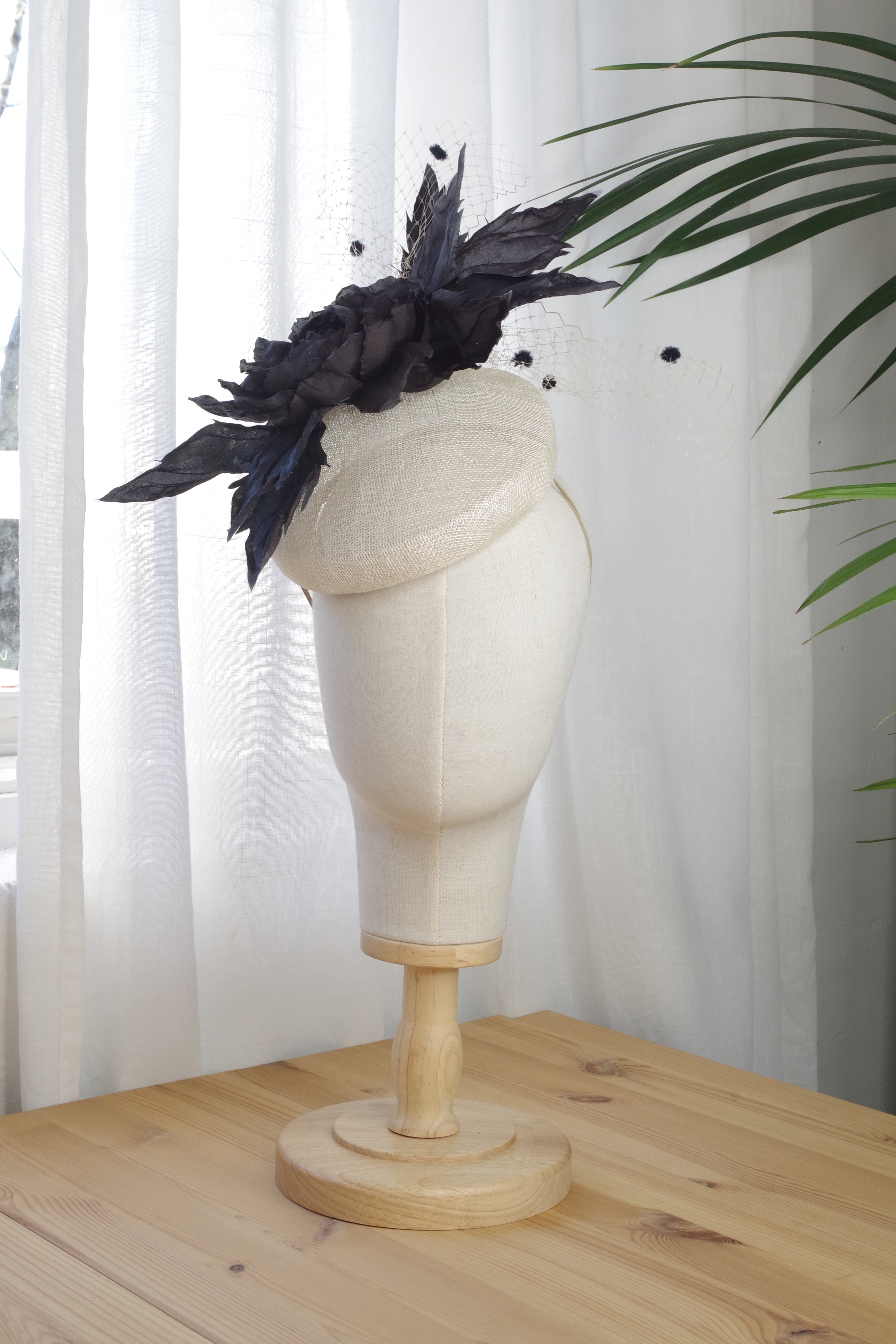 Handcrafted ivory sinamay fascinator by MICHAETT featuring a handmade black silk flower.