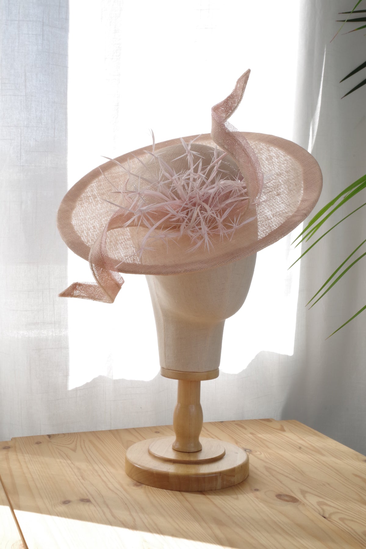 Side view of sand sinamay occasion hat with pink feathers by MICHAETT