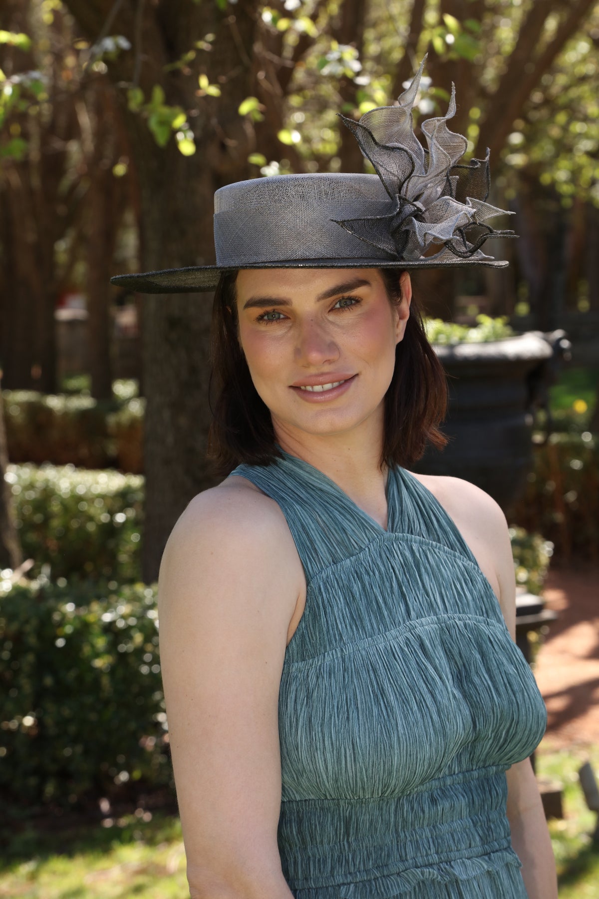 Green occasion hat with sculptural sinamay detailing worn for Spring Racing Carnival by MICHAETT